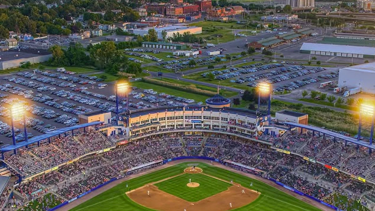 Aerial view of NBT Bank Stadium during a Syracuse Mets game at golden hour with the Syracuse skyline. Photo: AIDEMEDIA