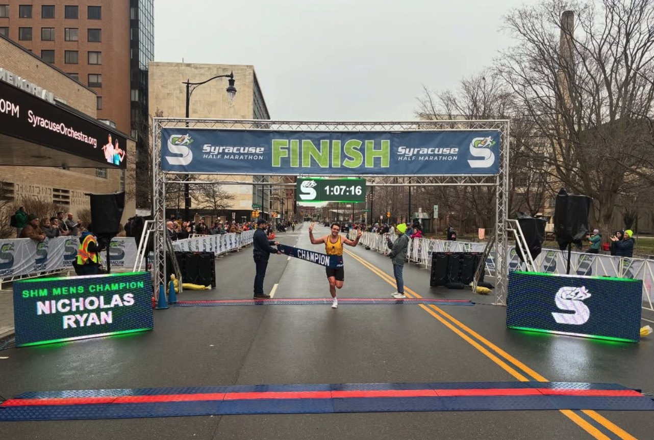 Nicholas Ryan crosses the finish line as 2026 Syracuse Half Marathon mens champion in 1:07:16