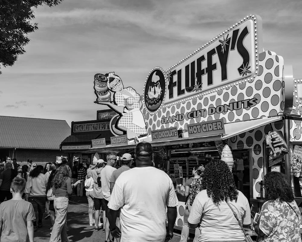 Fair donut stand with crowd