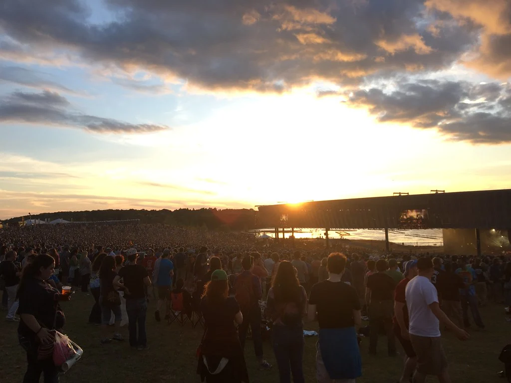 Sunset over a Phish concert crowd at St Josephs Health Amphitheater at Lakeview in Syracuse NY on Onondaga Lake