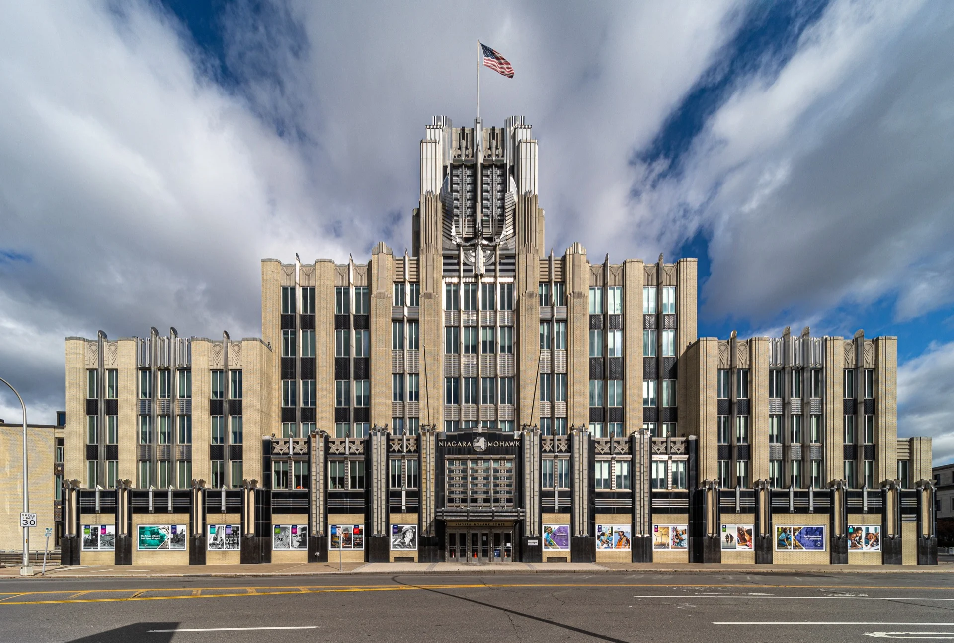 Front facade of the Niagara Mohawk Building in Syracuse showing its winged stainless-steel Spirit of Light sculpture and Art Deco massing.
