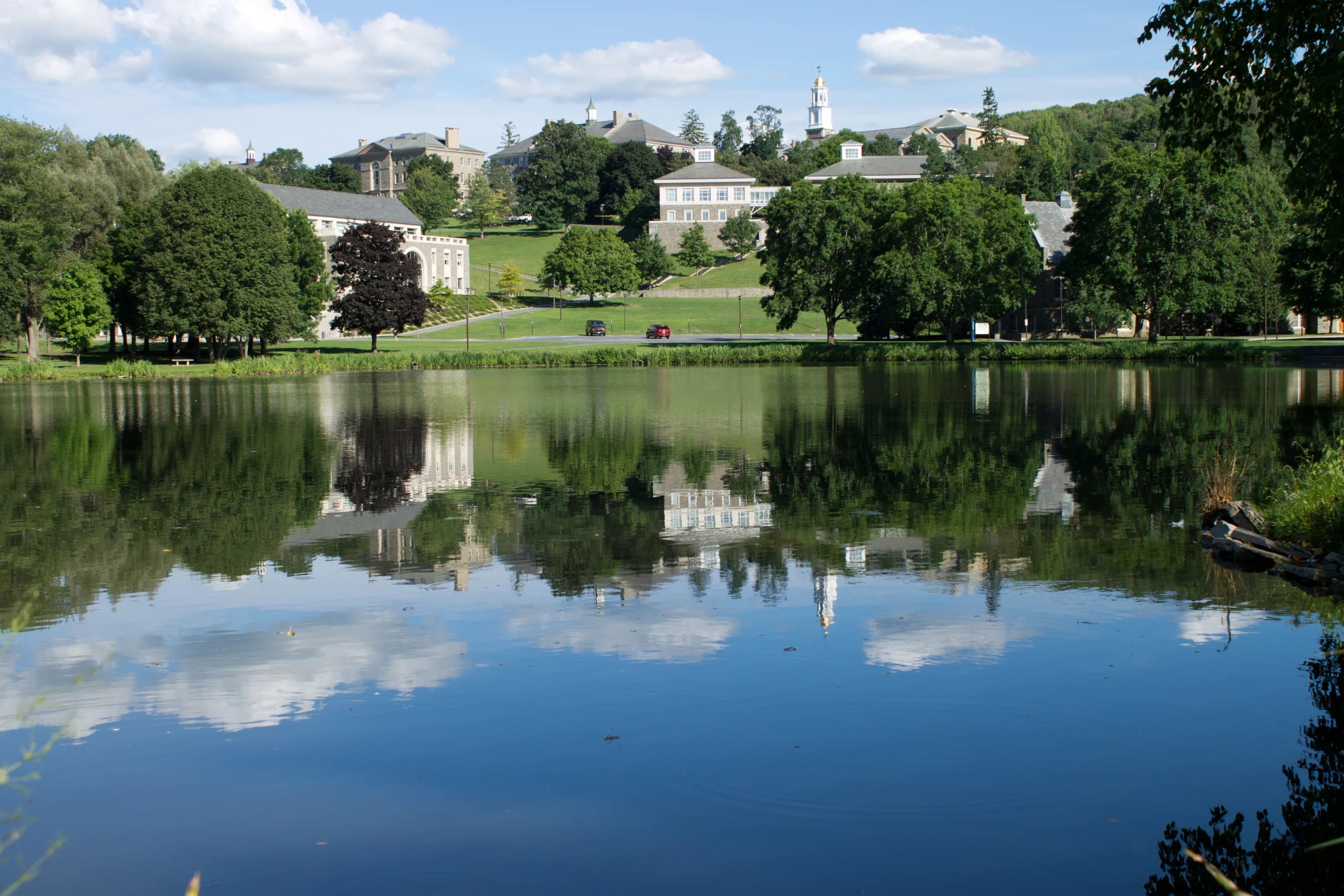 Colgate University's stone campus buildings on the hill above Taylor Lake in Hamilton, New York