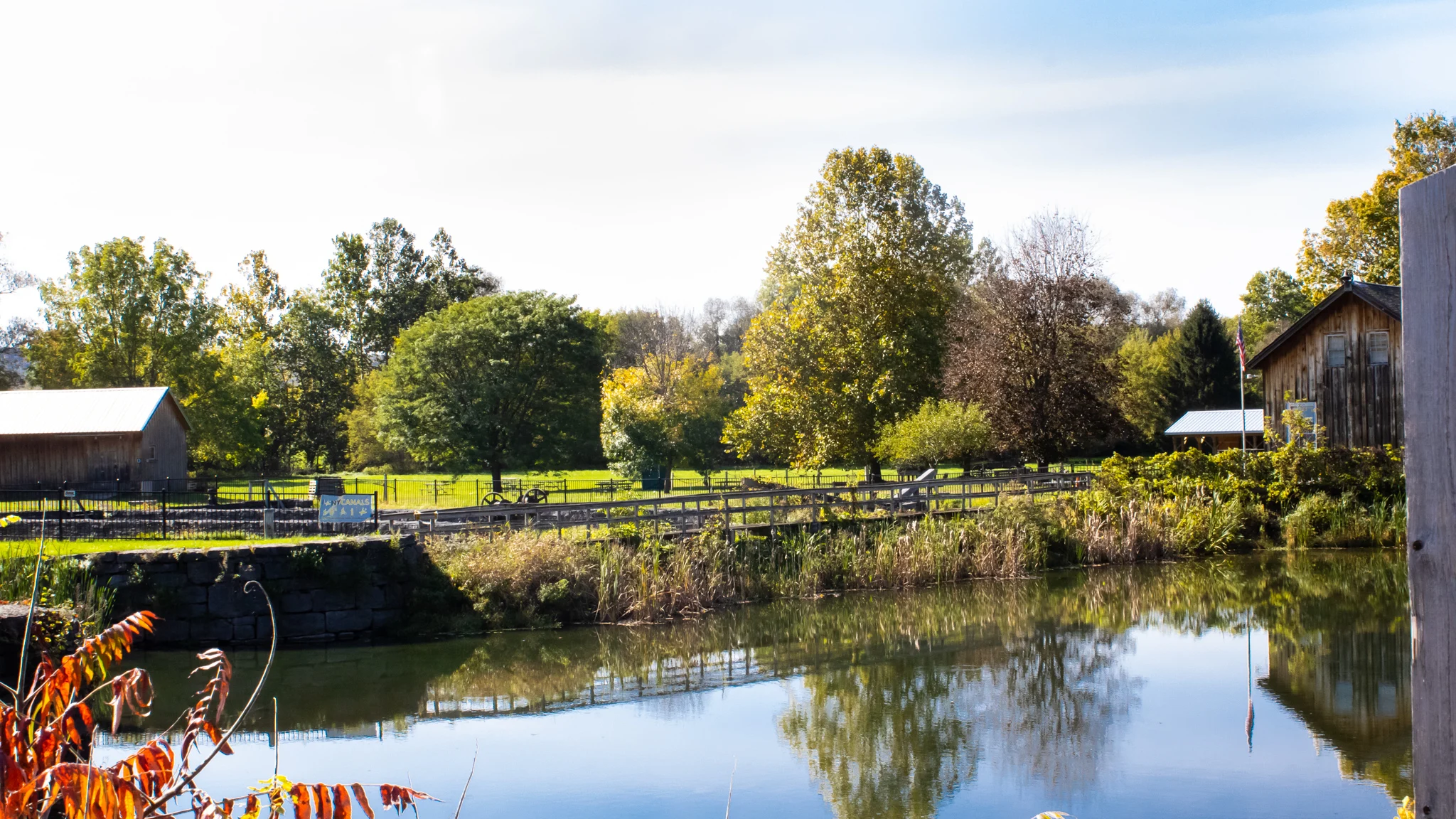 The stone lined dry dock basin at Chittenango Landing Canal Boat Museum reflecting fall trees