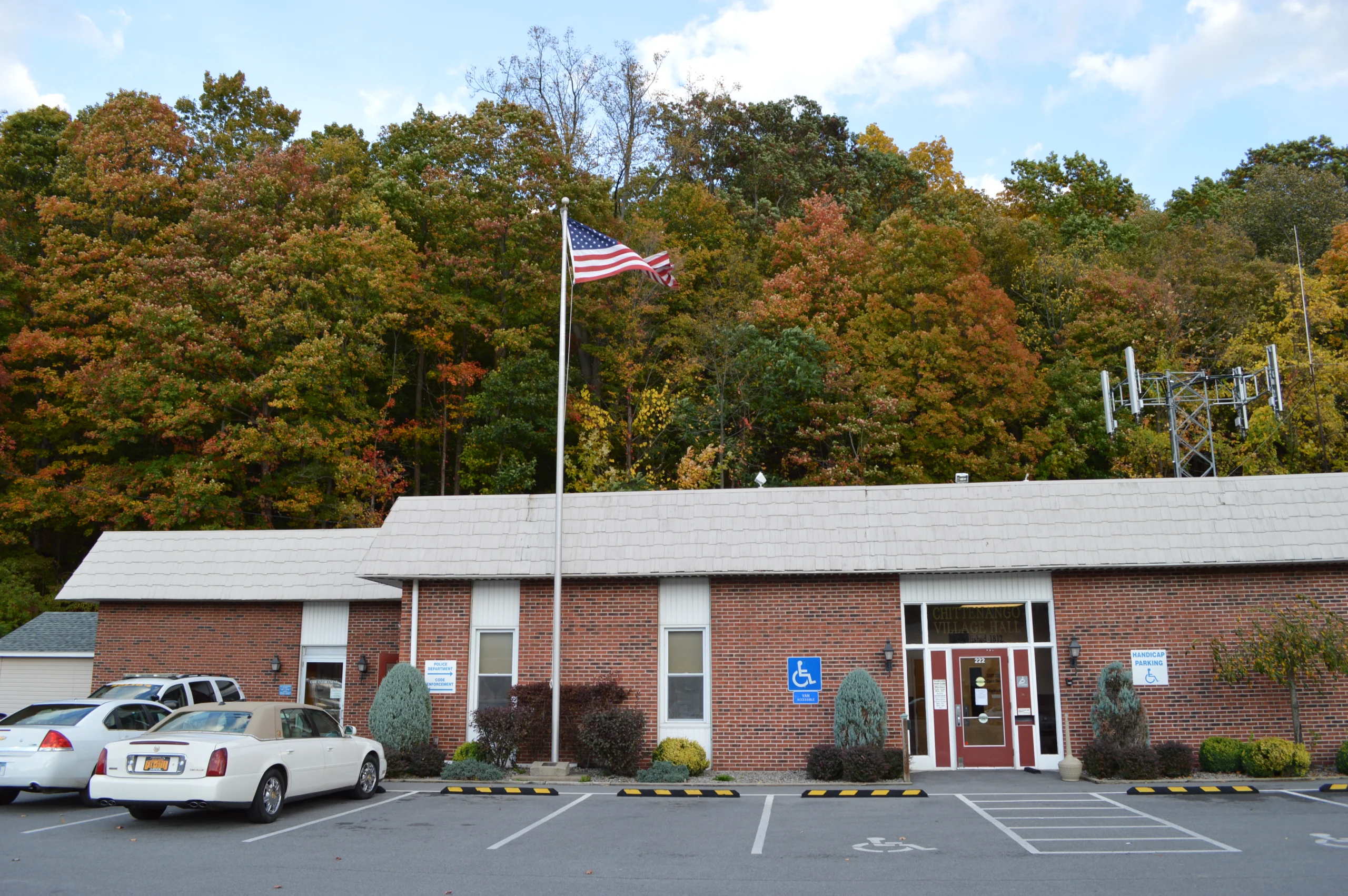 The brick Chittenango Village Hall at 222 Genesee Street with its flagpole and police department signage