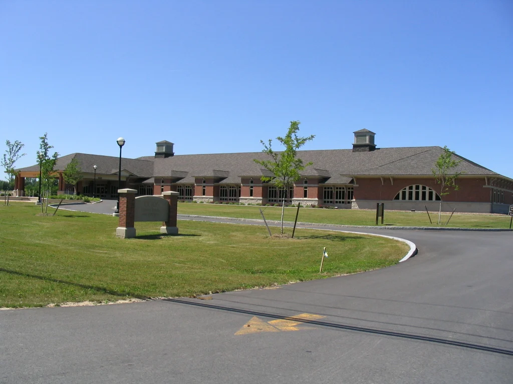 The brick Clay Town Hall building with its curved entrance drive