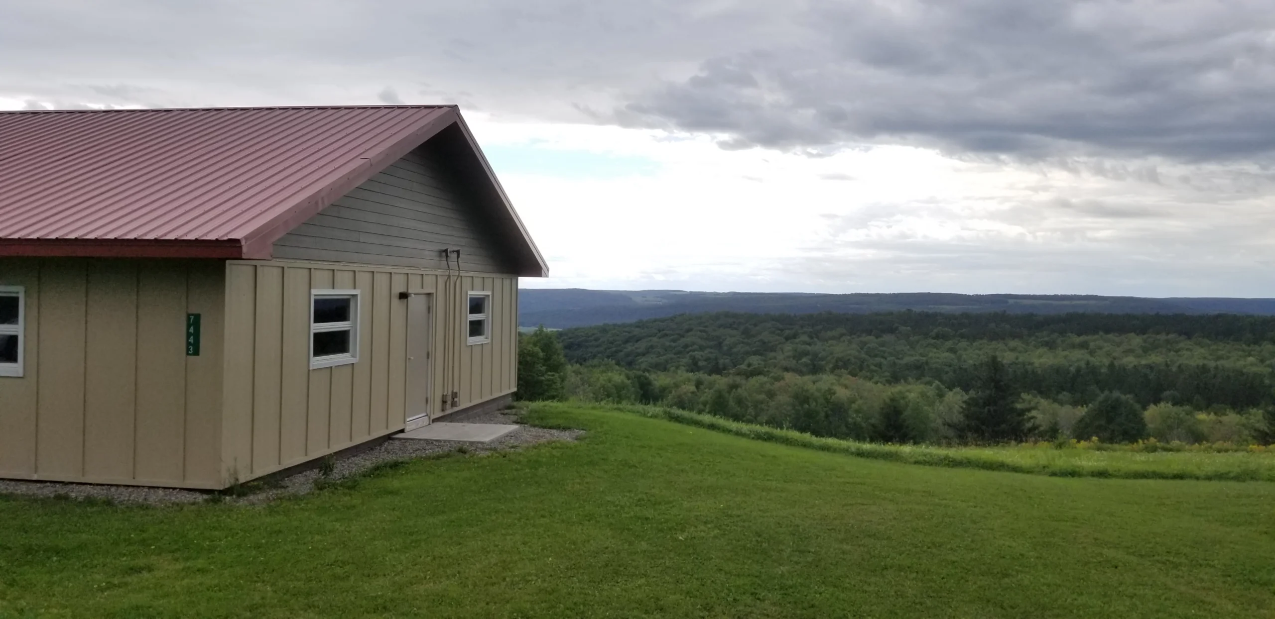 A classroom building at Heiberg Memorial Forest overlooking the forested hills of the Tully valley
