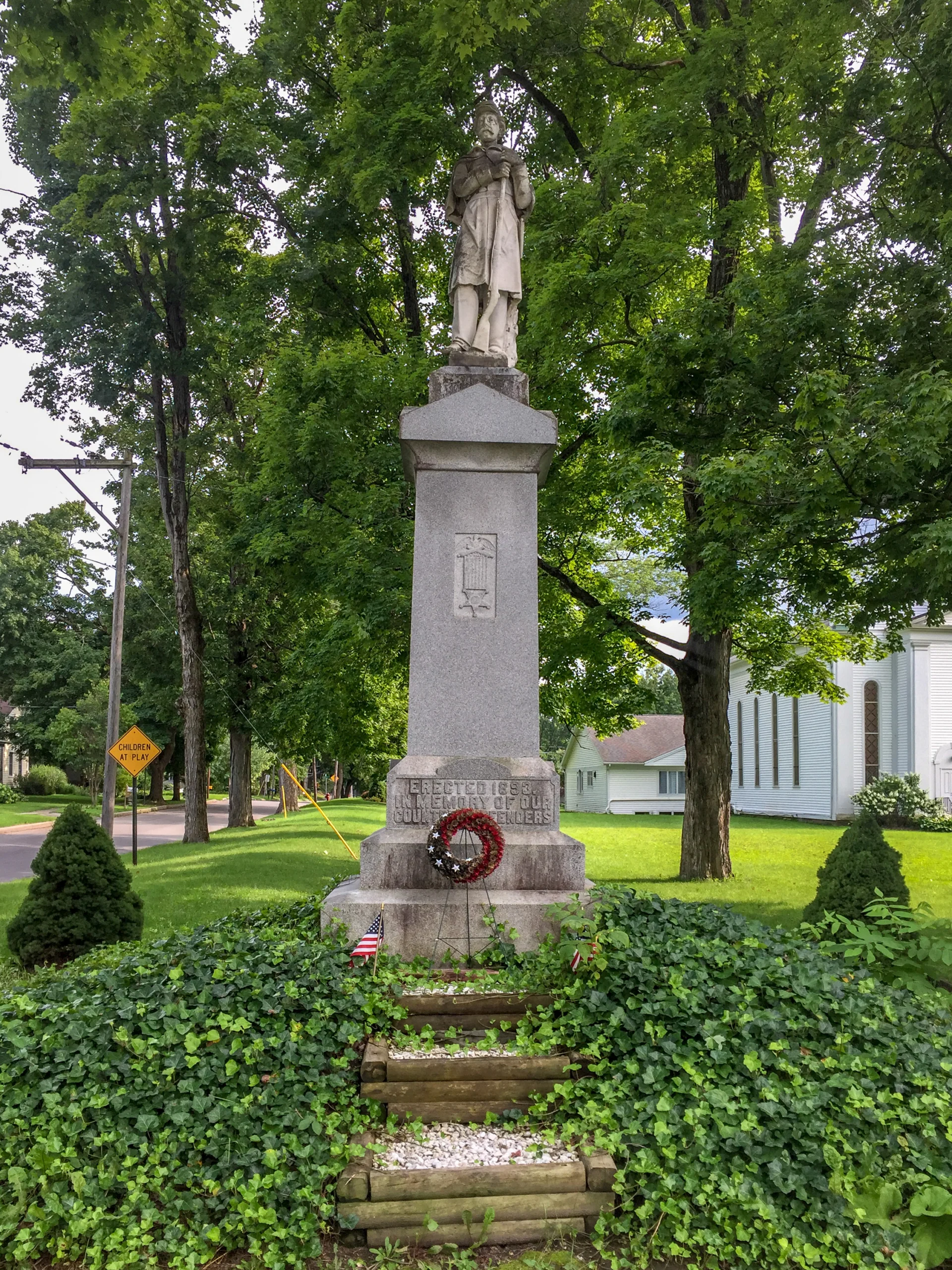 The granite 1893 soldiers monument topped by a stone soldier in the village of Moravia
