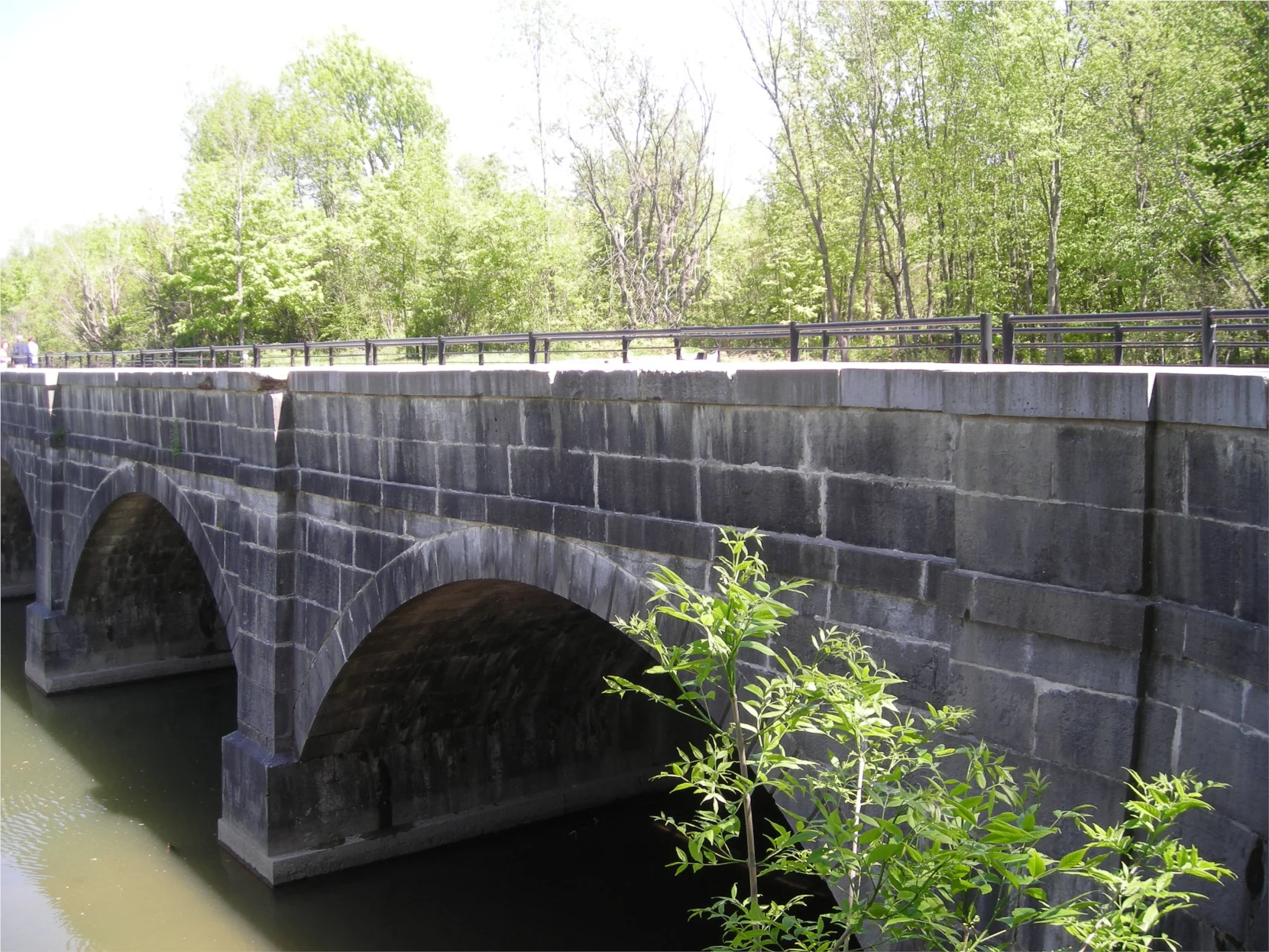 The stone arches of the Nine Mile Creek Aqueduct crossing the creek at Camillus Erie Canal Park
