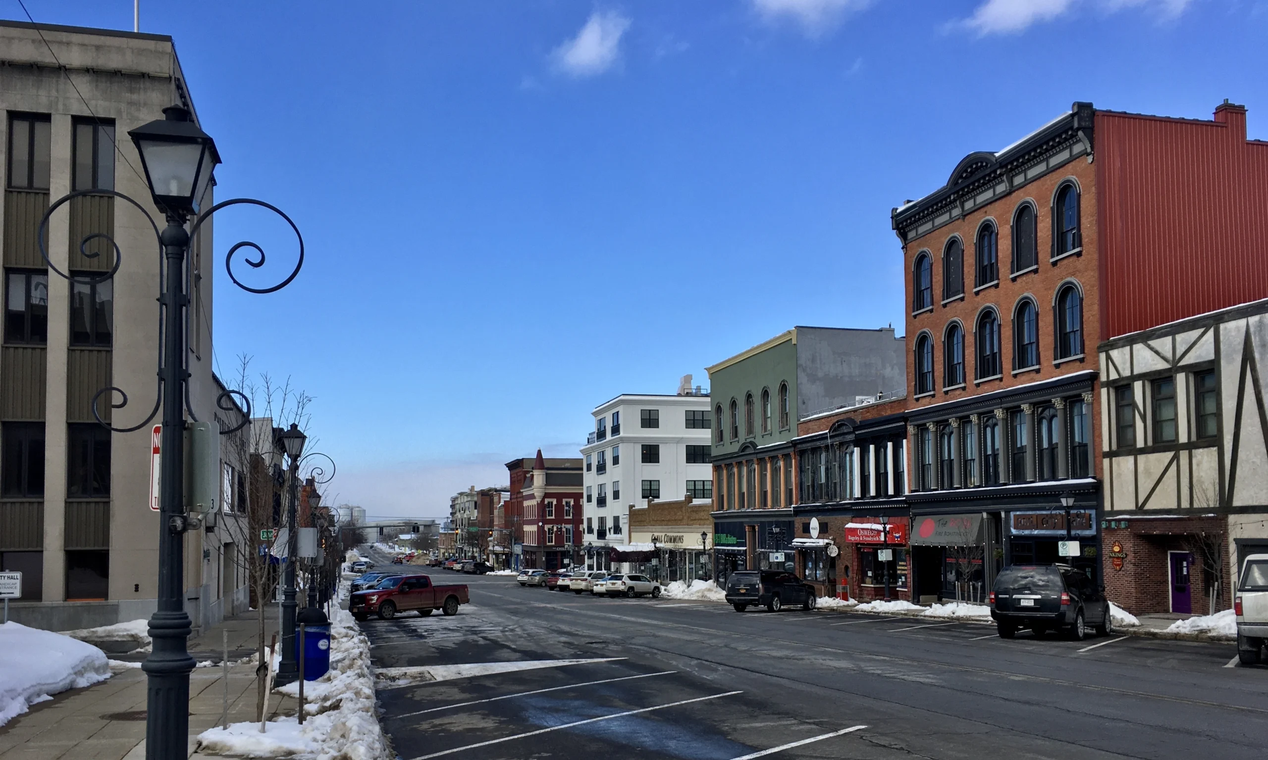 Storefronts and brick buildings lining West First Street in downtown Oswego