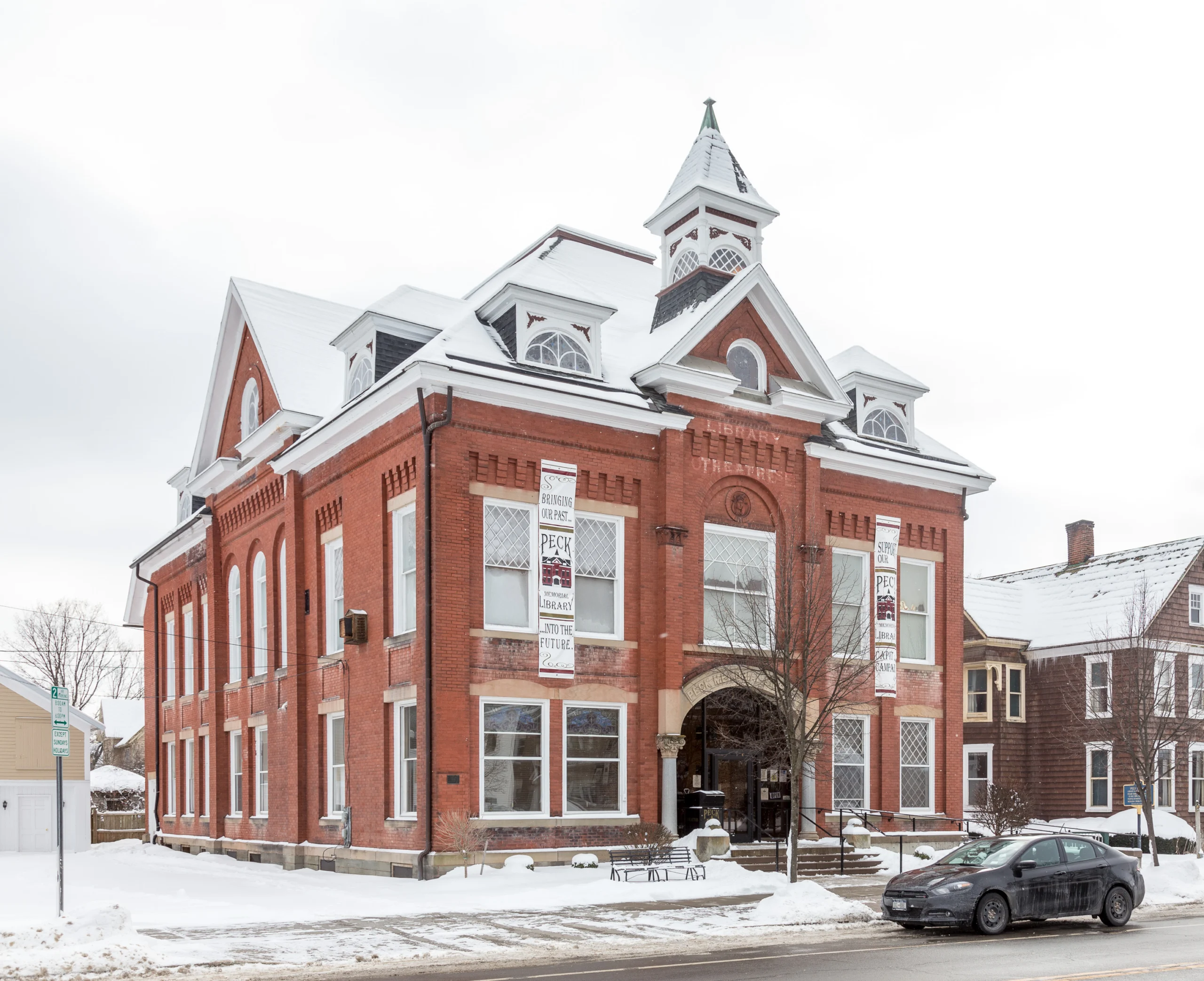 The 1898 brick Peck Memorial Library in Marathon with campaign banners hanging between its windows