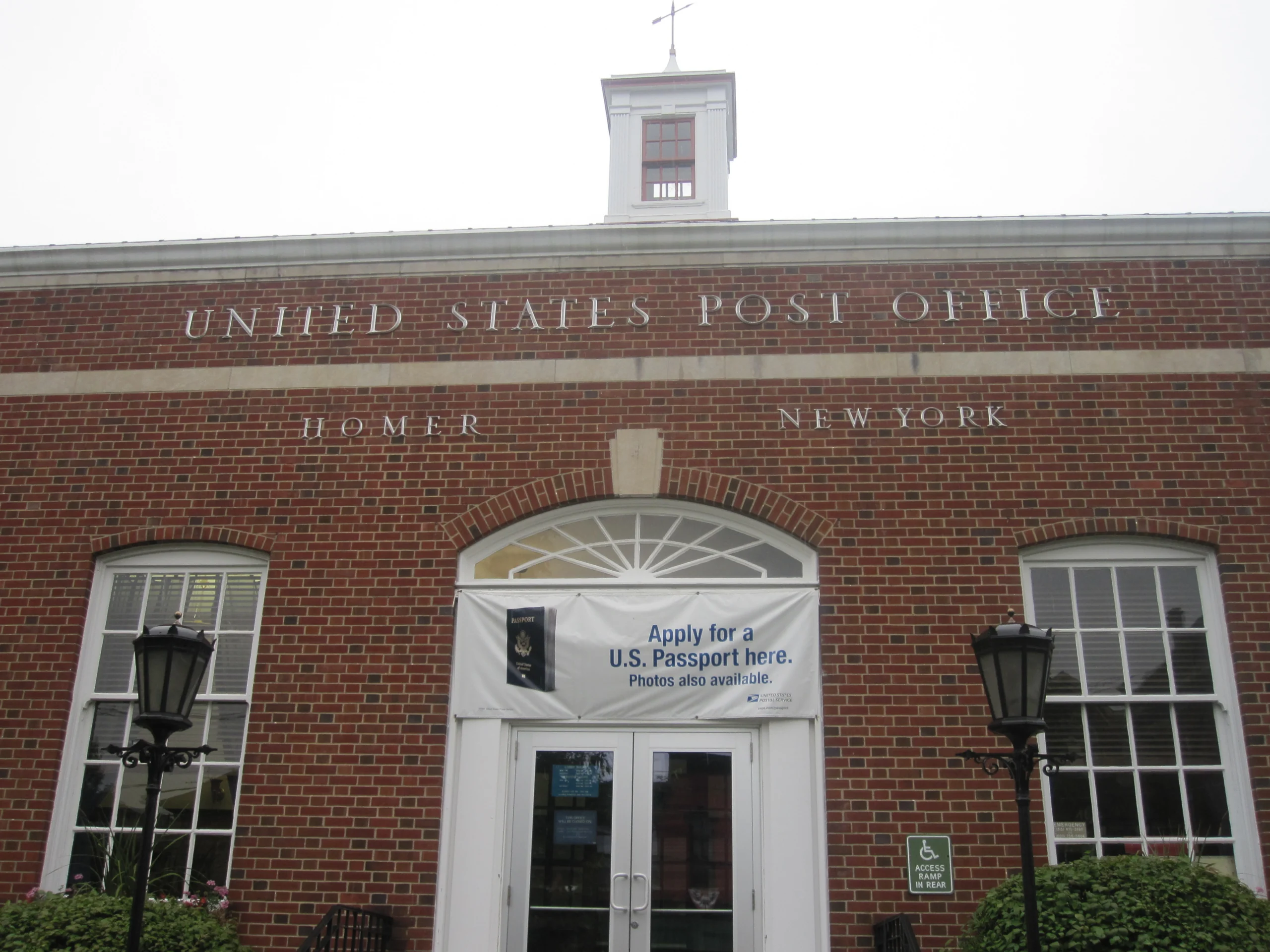 Brick United States Post Office building with HOMER NEW YORK carved into the stone facade
